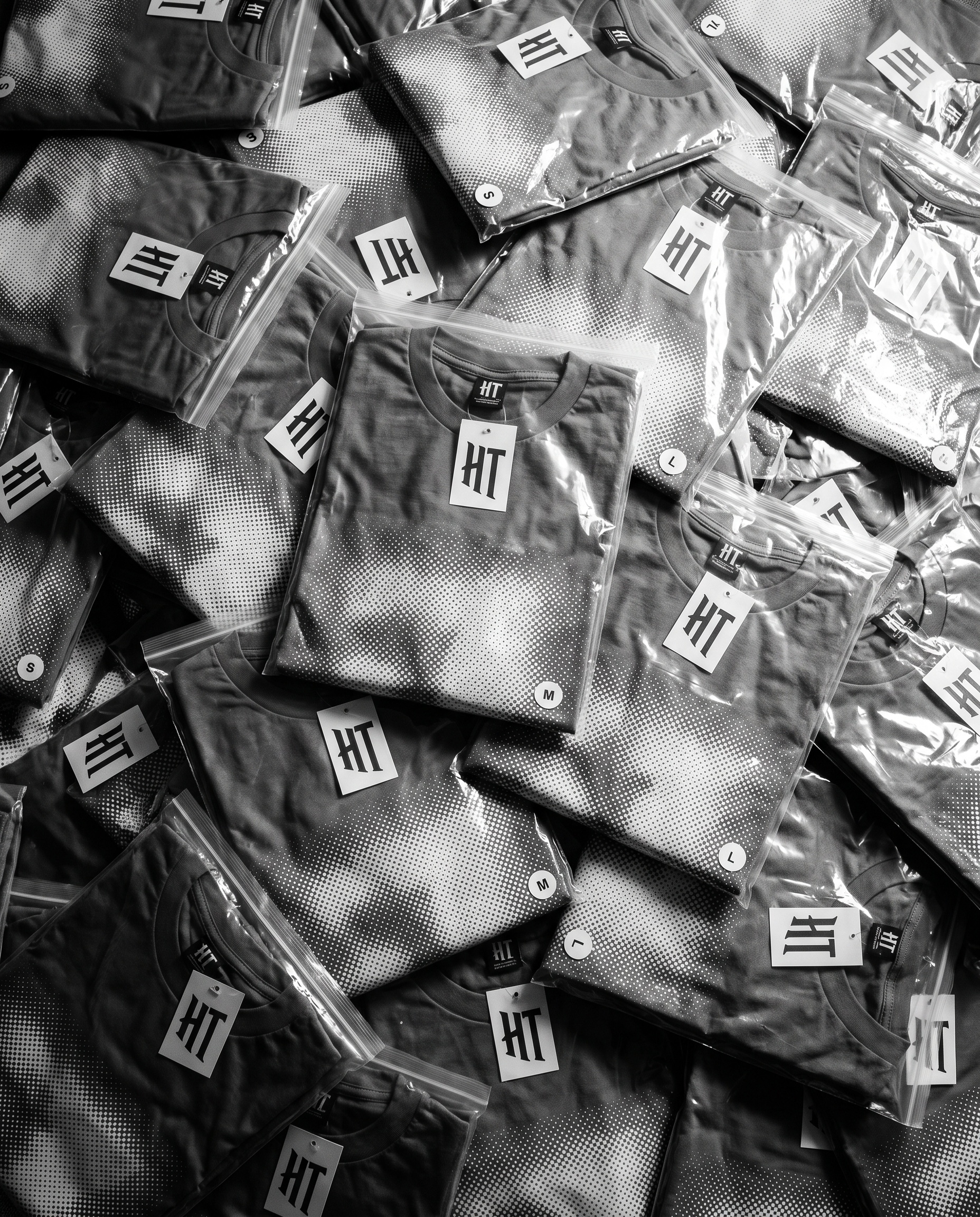 Pre-pack being assembled: even size run stacks with tickets, hang tags and strip tape
